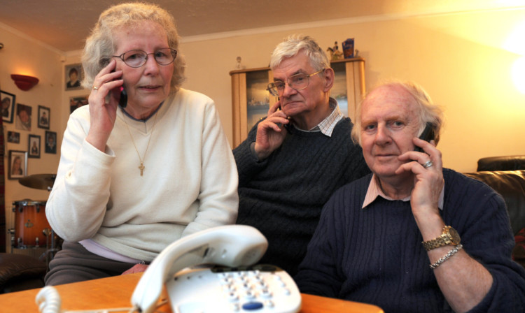 Newburgh neighbours Wendy and Martin Ramwell and Rab Stark, right, have no option but to use their mobile phones as they have been without a landline service for 10 days.
