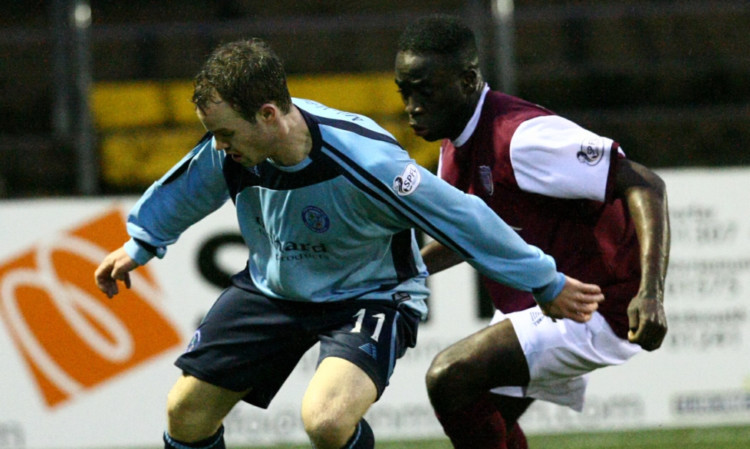 Forfars Gavin Malin up against David Banjo of Arbroath during the December clash at Station Park.