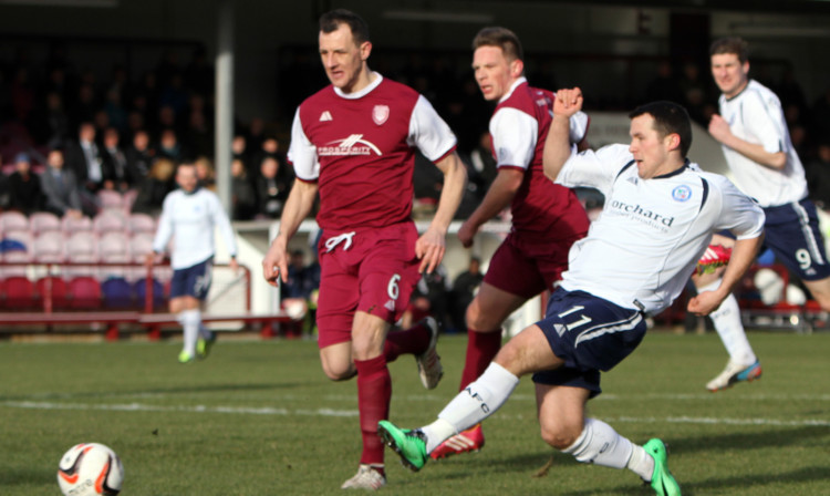 Lichties defender Alex Keddie can only watch as Dale Hilson fires Forfar ahead.