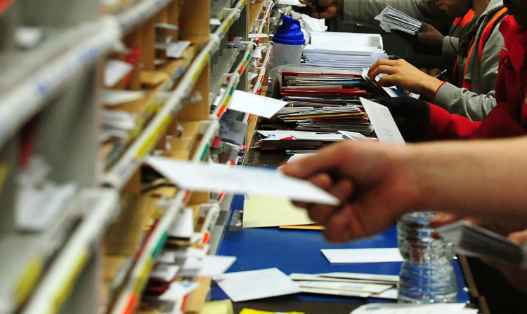 Royal Mail staff sort the post.