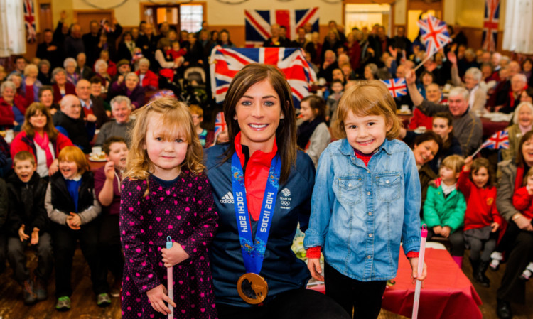 Eve Griffiths, left, and Catriona Fernie presented Olympian Eve Muirhead with flowers at a celebration in Blair Atholl Village Hall.