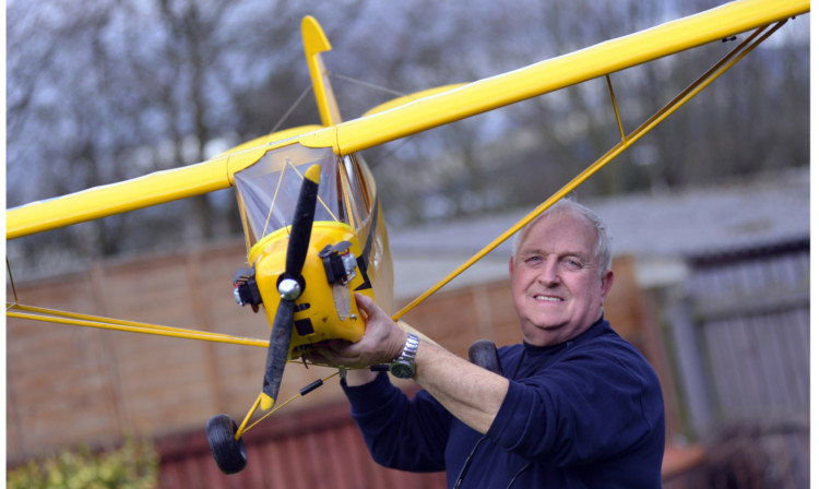 Colin MacLean, liaison officer with Scottish Aeromodellers Association, with his Piper Cub model aircraft for the upcoming exhibition taking place this month.