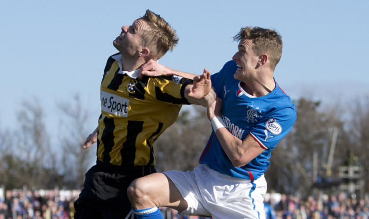 East Fifes Stephen Hughes in an aerial battle with Rangers Dean Shiels.