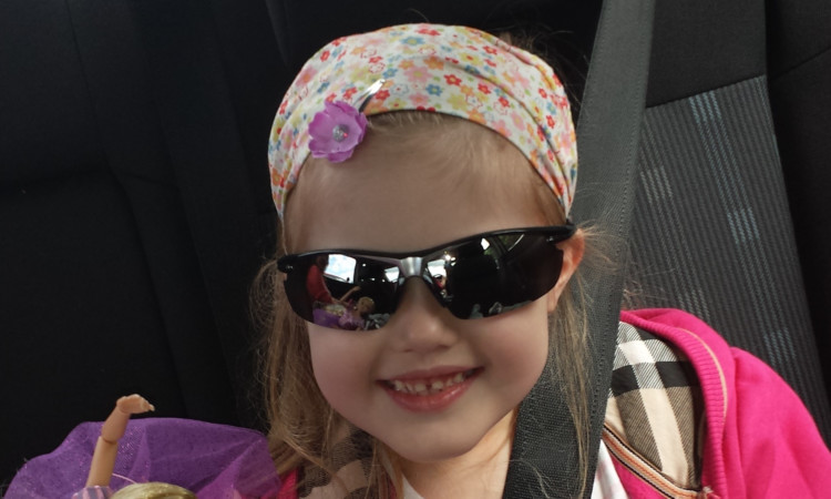 Sophie was all smiles in the taxi home from hospital after her surgery.