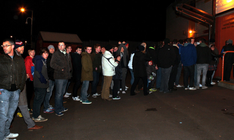 A long queue of fan waiting to get inside the ground a full 30 minutes after kick-off.