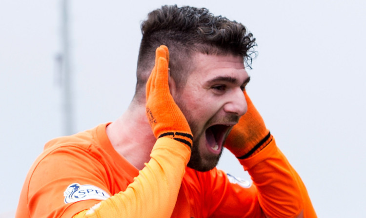 Nadir Ciftci goes to the fans after scoring United's second goal.
