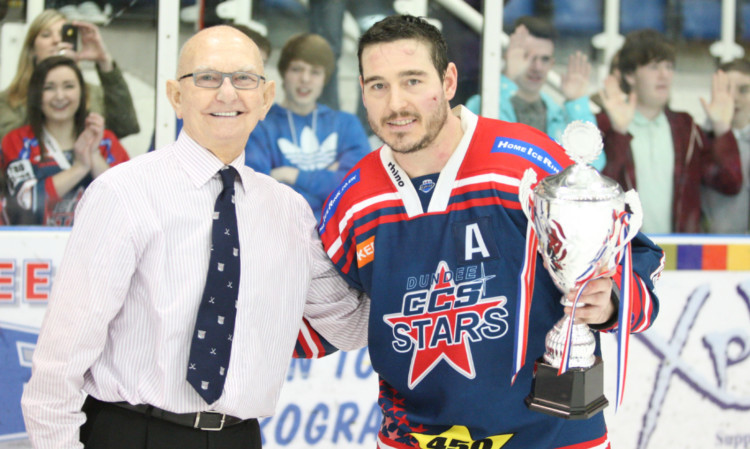 Billy Bargon collects the trophy from Dundee Ice Arena chairman Malcolm Reid.