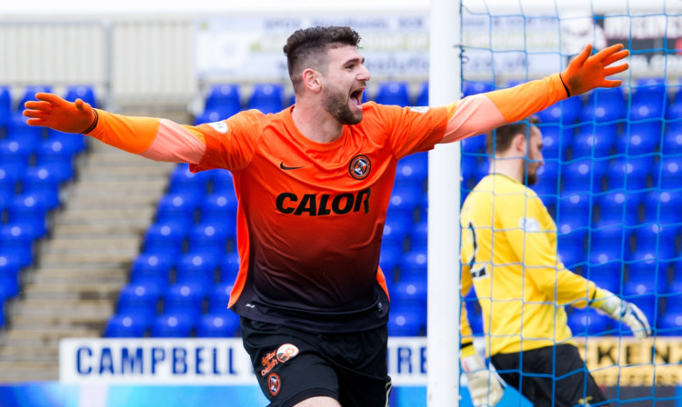 Nadir Ciftci celebrates after giving United a 2-0 lead with his second goal of the quarter-final tie.