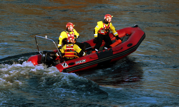 A team searching the river on Tuesday afternoon.