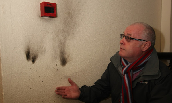 Councillor David Fairweather inspects the damaged caused by wreckless firestarters.