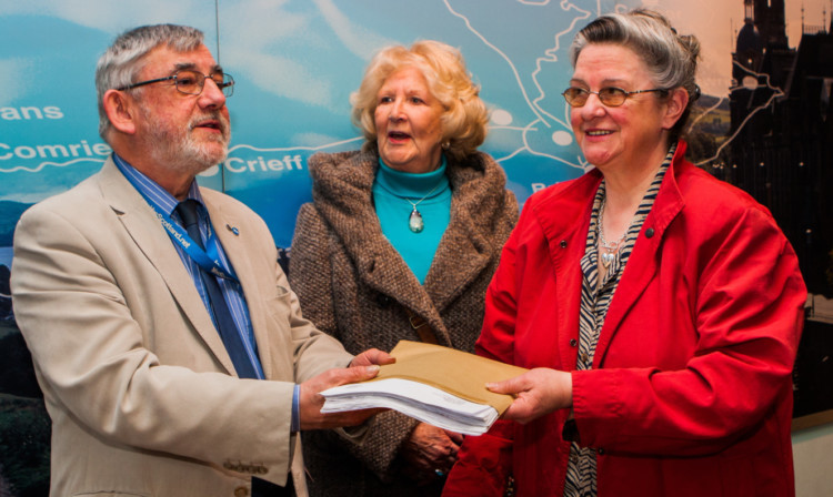 Councillor Alan Grant receiving the petition from Sybil Mcfarlane and Irene Hamilton.