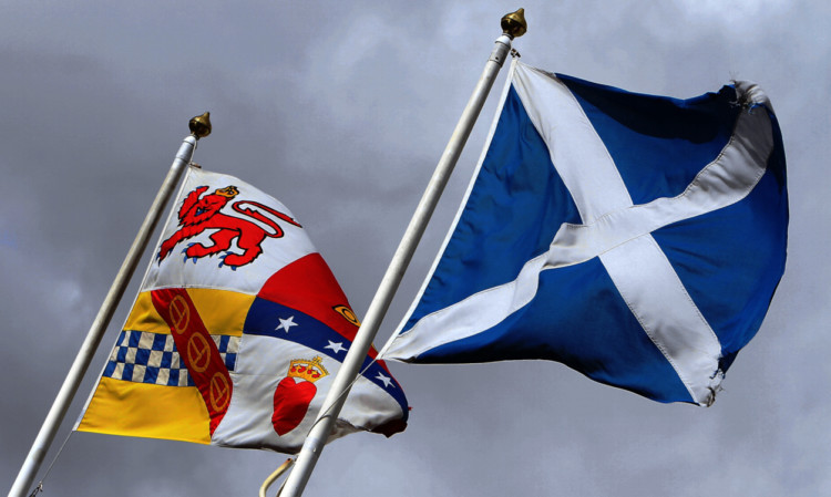 The flag showing the coat of arms of Angus and the saltire fly side by side.