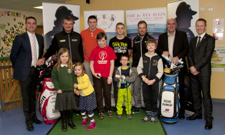 Paul Lawrie (back second left) and Richie Ramsay (back third right) alongside David Park (far left), charity executive of the European Tour, and staff and children from the ARCHIE Foundation at the Royal Childrens Hospital in Aberdeen.