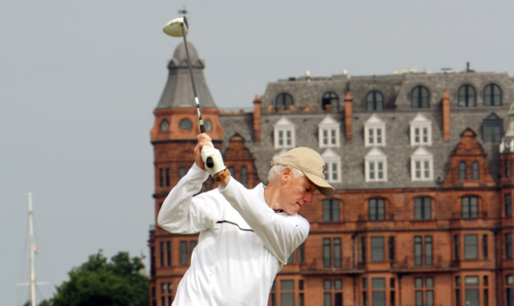 The building has provided the backdrop to countless rounds of golf at the Old Course, including this one by former US President Bill Clinton.