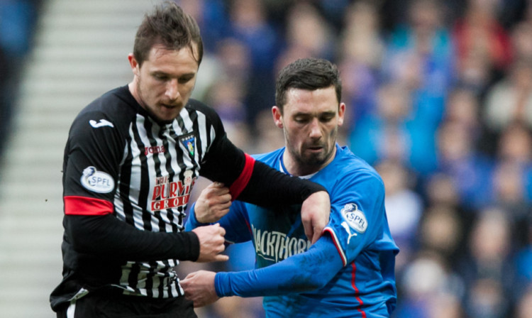 Dunfermline's Callum Morris battles with Rangers' Nicky Clark.