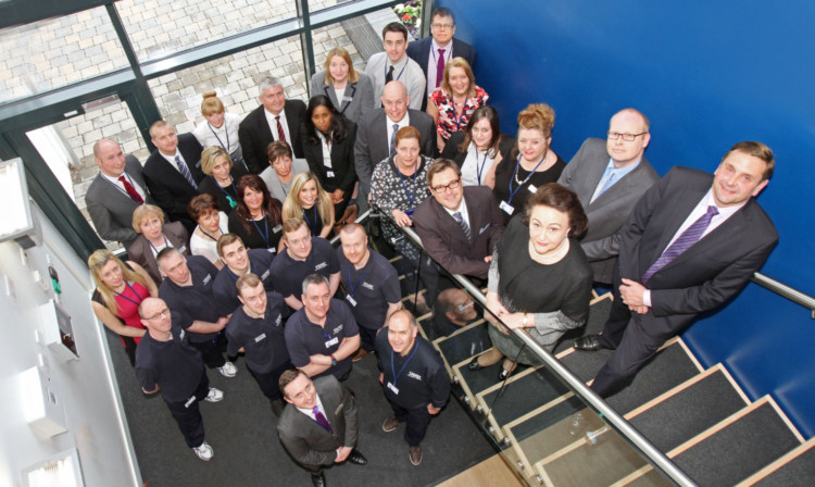 Staff with, at the top of the stair, Dr Sybill Storz and her son Karl-Christian Storz.