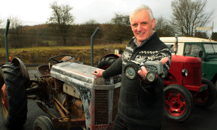 Strathmore Vintage Vehicle Club chairman Allan Burt with a wee Fergie model made by Chad Valley on the bonnet of the real thing.