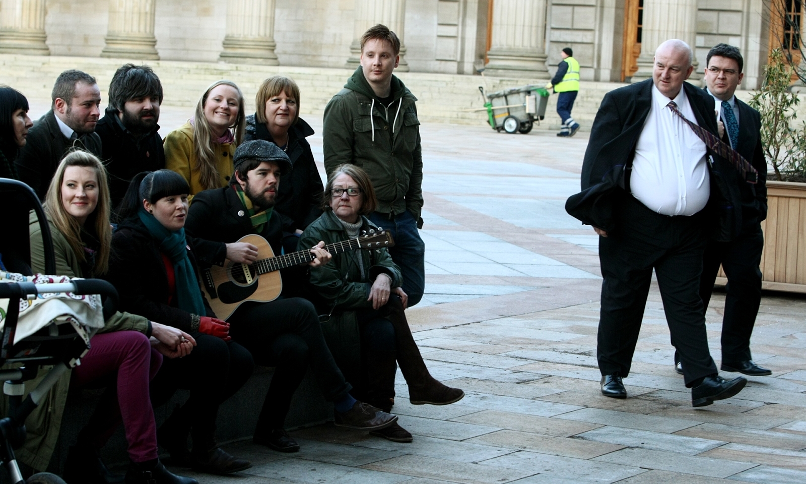 COURIER, DOUGIE NICOLSON, 24/03/14, NEWS.
Pictured in the City Square in Dundee tonight, Monday 24th March 2014, is Andrew Mitchell from the Hazey Janes (with guitar) and some of the others who gathered to support the Sistema Bid as Councillors Kevin Keenan and Richard McCready make their way into the meeting. Story by Andrew, reporters.