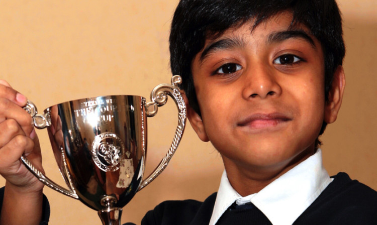 Six-year-old Rayyan Khan lifts the Courier Cup.