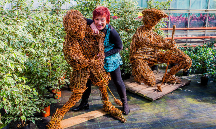 June McEwan with two of her designs.