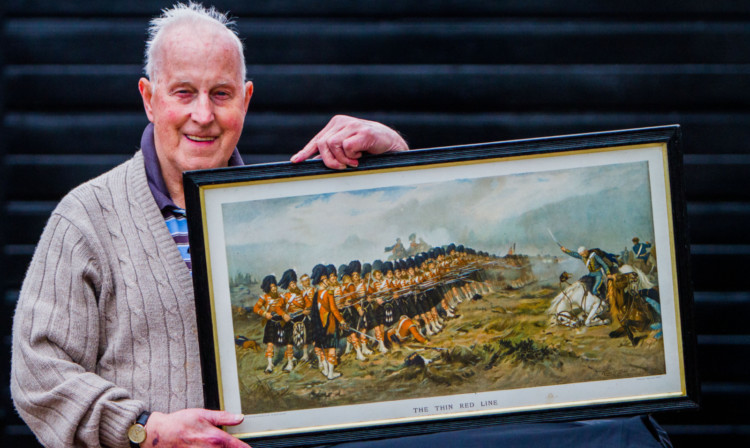 Reggie Gates with his print of The Thin Red Line.