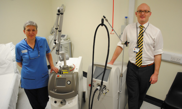 Charge nurse Camilla Keir and consultant plastic surgeon Stuart Waterston with one of the new lasers.