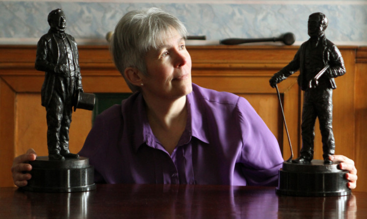 Secretarial assistant Jenny Henderson with the new bronze trophies of David Todd, left, and Allan Robertson.