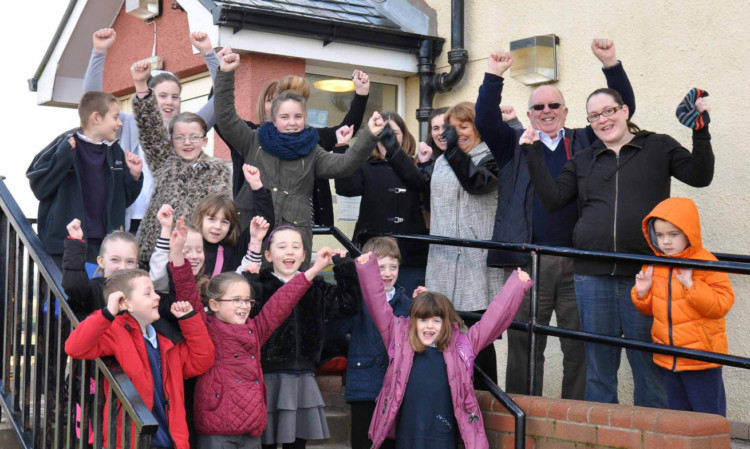 Children and parents at Crombie Primary School protest outside the school.