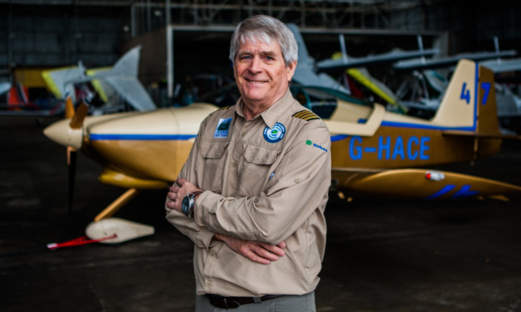 Dave McElroy alongside his own single-engine plane, which is similar to the aircraft he will use to travel around the world.