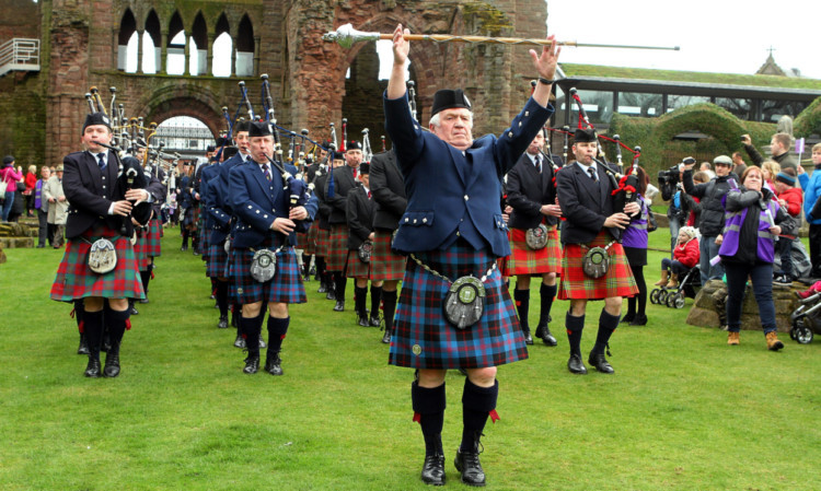 Drum Major David Gibson as he leads the massed pipe bands of Strathmore, Forfar, Arbroath, carnoustie and Brechin in to the Abbey grounds.