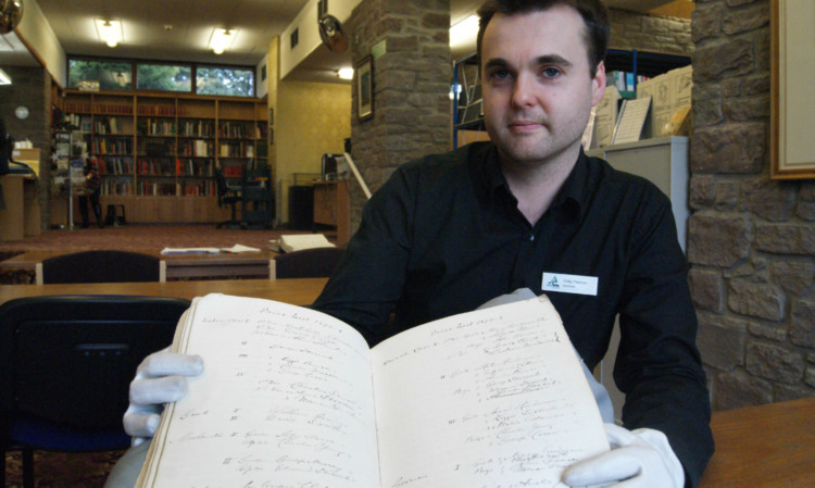 Angus Archives archivist Craig Pearson with the book discovered at the Arbroath campus of D&A College.