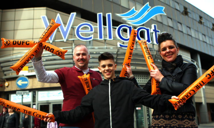 There was cup fever outside the Wellgate Centre yesterday as The Courier gave away thundersticks ahead of Dundee Uniteds semi-final clash with Rangers. From left; John Boyd, Kyle and Clare McDonald.