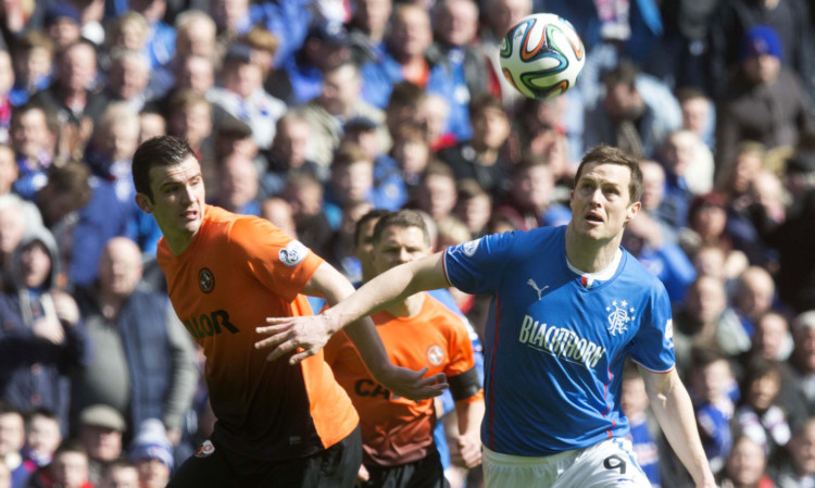 Gavin Gunning battles with Rangers striker Jon Daly for the ball during the  Scottish Cup semi-final match at Ibrox.