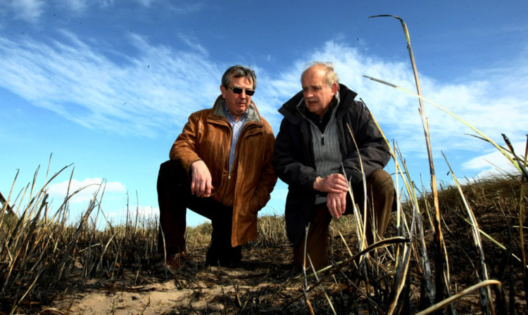 Monifieth Community Council chairman John Whellams, left, and vice-chairman Sandy Ritchie discuss the burnt grass at Monifieth beach after a series of fires in the town.