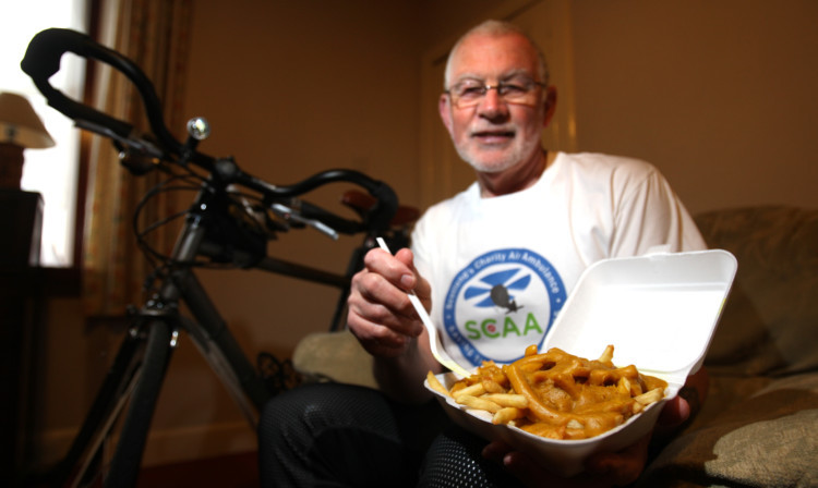 Bob Ellis on his bike in Blairgowrie training for his charity bike ride and, inset, with his favourite training food  curry and chips.