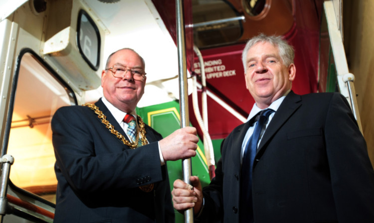 Lord Provost Bob Duncan being shown round one of the buses at the Dundee Museum of Transport by chairman Jimmy McDonnell.