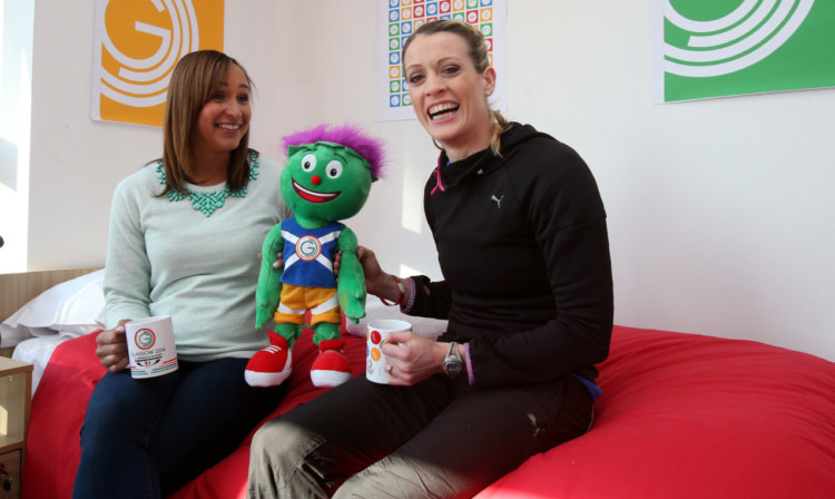 Jessica Ennis-Hill and Eilidh Child relax with Games mascot Clyde in the Athletes' Village.