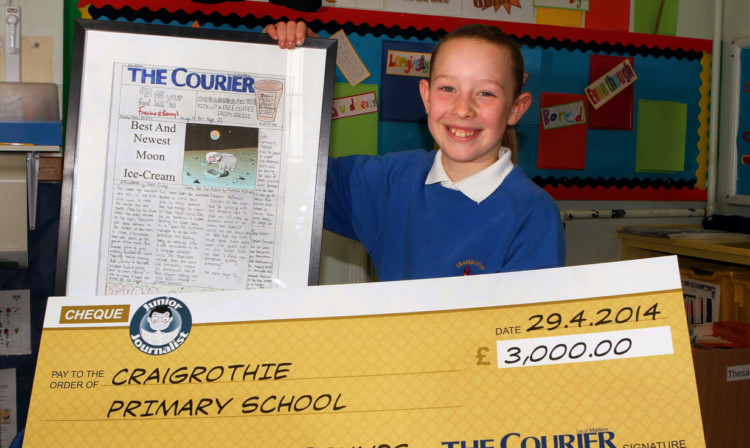 Grace Finlay with the winning cheque and her winning front page.