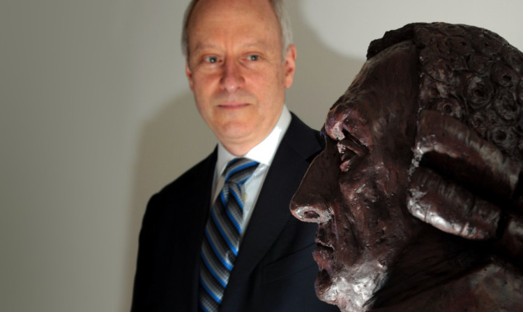 Professor Sandel gazes at a bust of Adam Smith at Fife College.