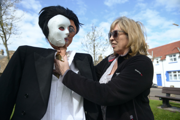 Jenny Watkins puts the final touches to her Phantom of the Opera scarecrow. A record-breaking field of straw-thin models will be on show during the third annual Elie Scarecrow Festival this weekend. Maps/guides showing where the scarecrows are displayed around the village are on sale (£2) in local shops. Prizewinners will be announced on Monday at 2pm on Toll Green, Elie.