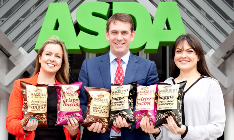 Daisy Swiers, left, and Lisa Benvie of Asda with George Taylor of Mackies Crisps, which has secured a major step-up in its listings with the chain.