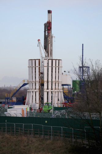 An anti-fracking protestor is removed by police from the top of a truck carrying chemicals to the Barton Moss gas fracking facility on January 13, 2014 in Barton, England. Environmental protestors and anti gas fracking campaigners blocked roads and climbed on trucks arriving at the Barton Moss gas exploration site today. Earlier Prime Minister David Cameron promised local councils that they would get a financial boost from all the business rates collected from shale gas schemes.
