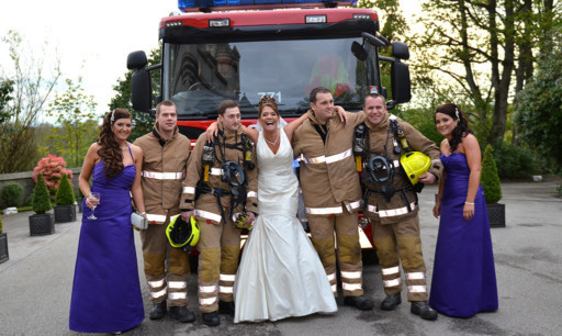 Bride Suzanne Davidson made the best of things when a fire alarm interrupted their wedding meal by posing with the crew.