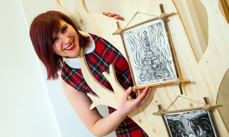 Charlie Dear with her artworks.