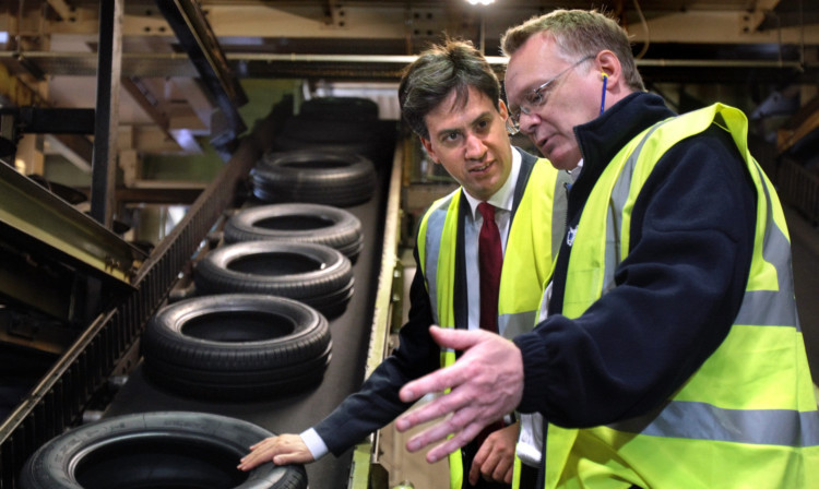 Labour leader Ed Miliband at Dundees Michelin tyre factory where he spoke to manager John Reid and other members of staff.