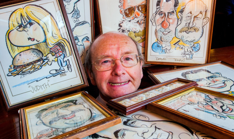 Proprietor Jonathan Stewart surrounds himself with the artwork by Brian Petrie to be sold off.