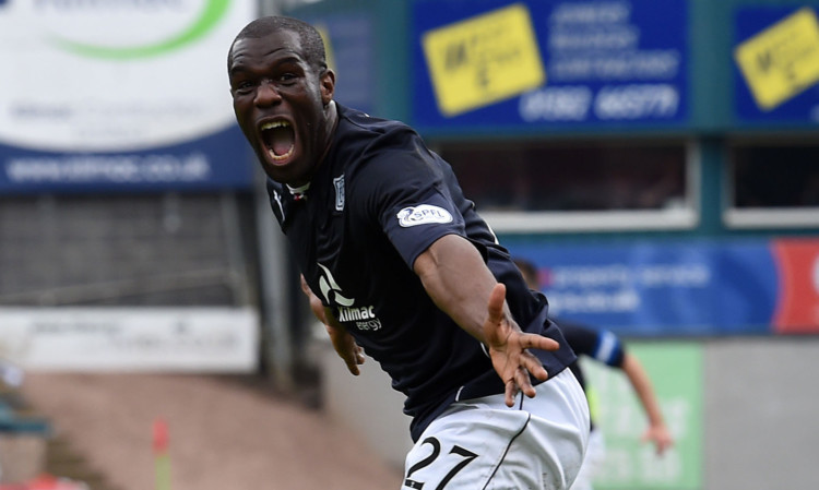 Christian Nade celebrates opening the scoring in Dundee's title-winning match against Dumbarton.