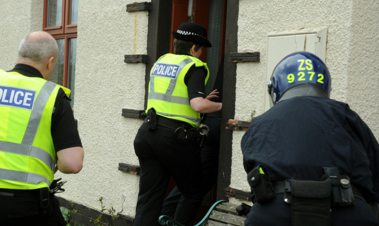 Police during a drugs raid in Angus.