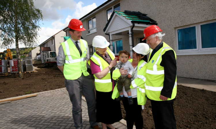 From left: Mr Doogan, Perth Provost Liz Grant, tenant Lawana Milne with son TJ and council leader Ian Miller.