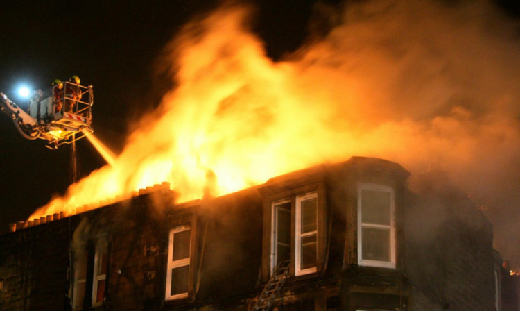 Firefighters tackle the blaze at its height.